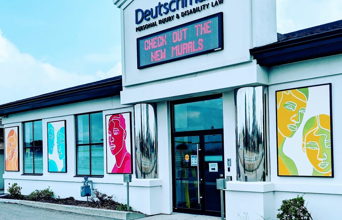 The firm's Kitchener office on Kingsway Drive, its front windows hung with the commissioned mural panels