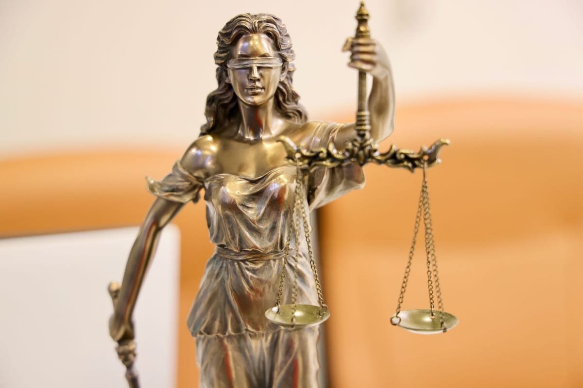 A close-up of a Lady Justice statue holding scales